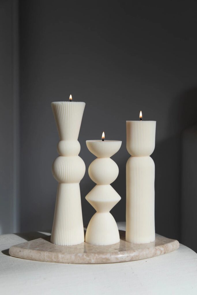 Ivory ribbed pillar candles on a stone tray