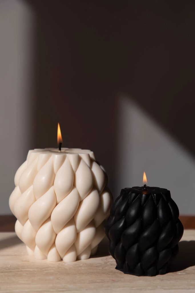 Ivory and black abstract knot candles, lit
